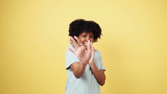 Young african american woman showing fear and disgust