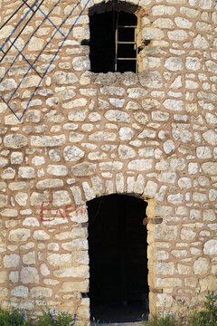 Old stone building with arched doorway and window