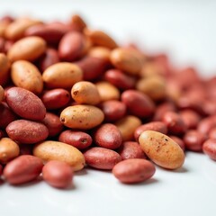 Obraz premium Close up pile of red and beige peanuts. Whole raw legumes are oval shaped with rough skin texture. Food ingredient background for cooking and nutrition.