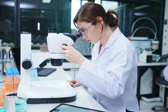 Laboratory Scientist Analyzing Samples with Microscope
