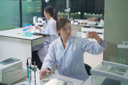 Scientist Conducting Chemical Analysis in Laboratory Setting