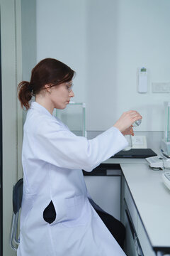 Scientist Conducting Chemical Experiment in Laboratory