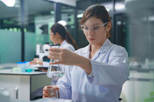 Scientist Conducting Chemical Experiment in Laboratory