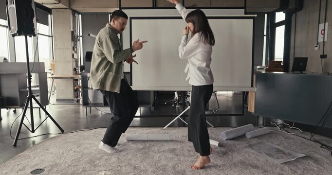 Two adults dancing in a modern rehearsal studio