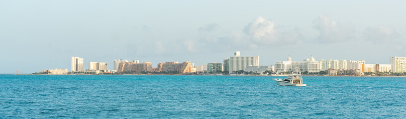 Naklejka premium Cancun skyline view across turquoise waters on a sunny day. Concept of tropical paradise vacations
