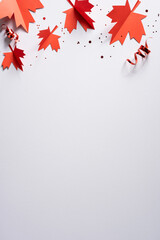 Obraz premium Red paper maple leaves and confetti for Canada Independence Day celebration with blank vertical space for text