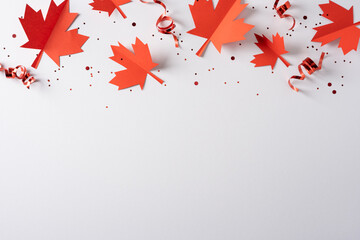 Naklejka premium Red paper maple leaves and curled ribbons for Canada independence day celebration with confetti and blank space
