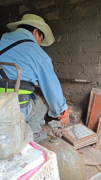 Construction Worker Moving Wall Tiles to Prepare Surface for Plastering