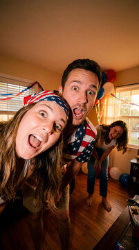 Playful friends posing at vibrant Fourth of July house party