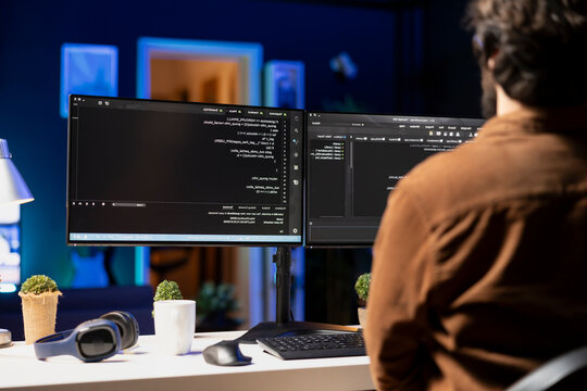 Man working from home implementing security measures to protect company systems and data; tech support IT worker writing, testing and debugging code for software applications.