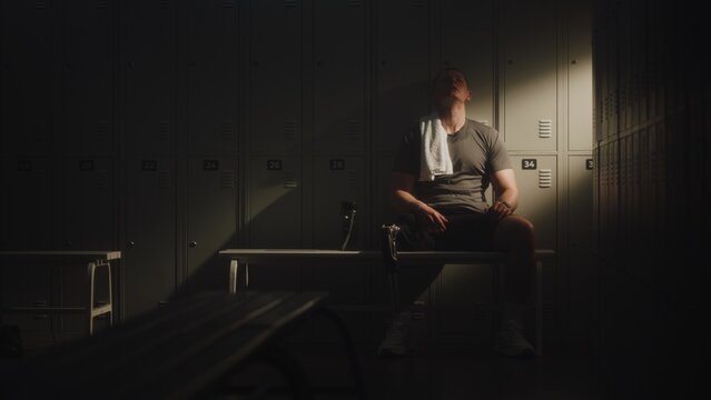 Modern Para Athlete Leans Back in Quiet Recovery After Intense Workout, Resting in Locker Room. Prosthetic Technology, Resilience, Authentic Representation of Disability in Active Lifestyle and Sport.