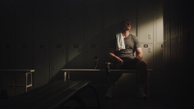 Modern Para Athlete Leans Back in Quiet Recovery After Intense Workout, Resting in Locker Room. Prosthetic Technology, Resilience, Authentic Representation of Disability in Active Lifestyle and Sport.
