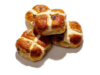 Fototapeta premium Three hot cross buns with golden crust on a white background. Popular classic bakery product. Traditional dessert. Tasty sweet food with high sugar level.