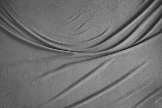 Soft grey gray fabric with a subtle texture and gentle folds. Ideal for backgrounds, textures, or representing delicate materials like cotton or fleece Crumpled Plastic Film Texture Background Folded