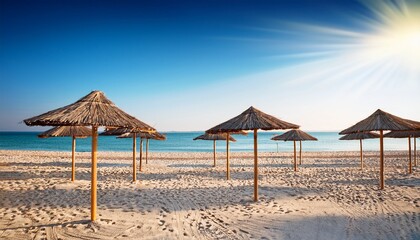 Fototapeta premium Straw Umbrellas On Empty Beach