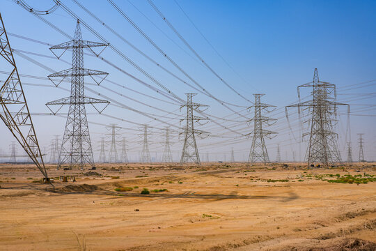 High voltage power lines and electricity pylons in the desert of Saudi Arabia