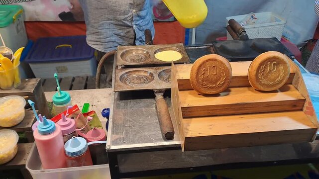 the process of making street snacks, namely Korean Cheese Coin Pancakes