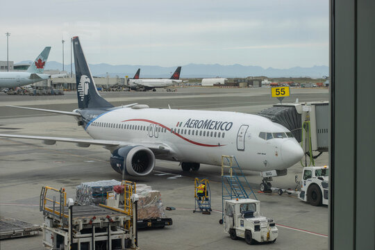 Richmond, BC, Canada - June 13, 2023: A Boeing 737 MAX 8 aircraft operated by AeroMexico, the flag carrier of Mexico, is seen through terminal building windows in Vancouver International Airport.