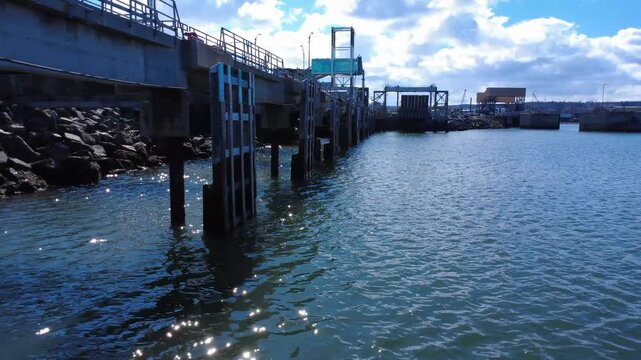 Drone footage along an industrial wharf showcasing ferry infrastructure, transport facilities and maritime operations at the Port of Matane, Quebec.
