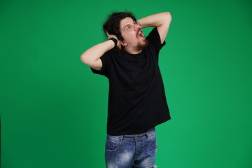 Fototapeta premium Real people. Man at his 20s, Medium shot, isolated on green screen in various poses and facial expressions. Studio capture with clean chroma key background, ideal for compositing