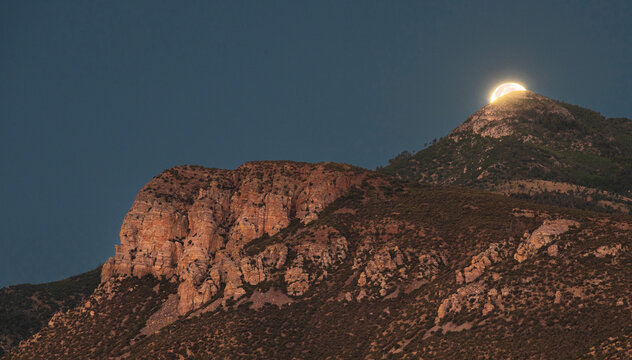 Moon setting behind the Huachuca Mountains just before dawn