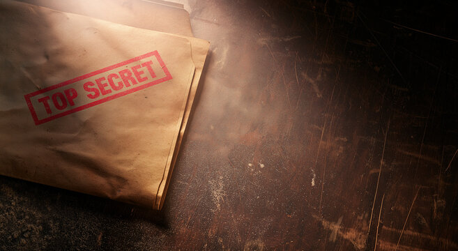 Top Secret Stamped Old File Folder on Wooden Desk
