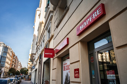 MADRID, SPAIN - FEBRUARY 22, 2026: Mapfre signs on an office facade in Madrid, showing red insurance company branding, Mapfre is a Spanish insurer specialized in life and non life insurance.