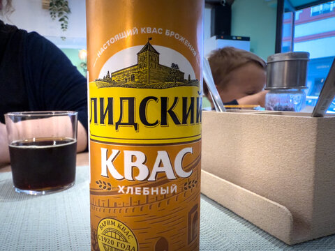 BELGRADE, SERBIA - MAY 9, 2026: Bottle of Lidsky Kvas, a Belarusian bread kvass made by Lidskoe Pivo, standing on a restaurant table in Belgrade beside a glass of dark drink.