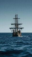 Fototapeta premium Europe medieval lifestyle. A serene maritime scene features a tall ship sailing across the vast expanse of the ocean. The ship, with its masts and rigging, is the main subject.