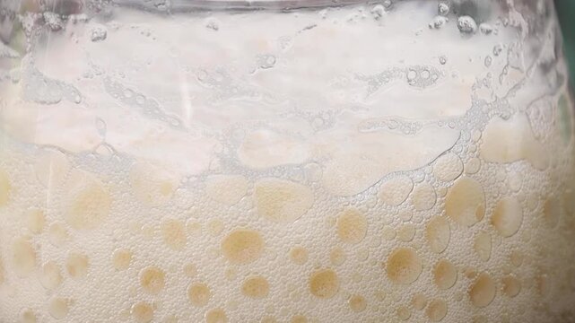 Video closeup of foam from a beer retracting.
