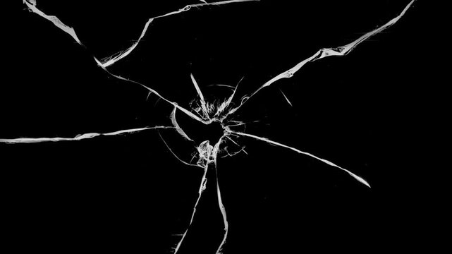 Cracked glass fracture effect on black background. footage of broken glass, crack screen glass.
cracks glass fracture effect texture isolated abstract black background. transparent 4K video.