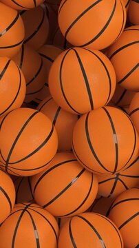 4k Resolution Vertical Video for Social Media: Basketball Sports Concept. Animated Falling Orange Basketballs Forming Piles On Green Screen Chroma Key Background With Alpha Matte