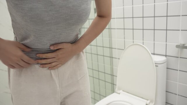 Constipation and diarrhea in bathroom. Hurt woman touch belly  stomach ache painful. colon inflammation problem, toxic food, abdominal pain, abdomen, constipated in toilet, stomachache, Hygiene