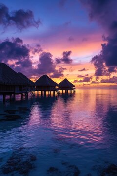 Overwater bungalows at sunset in bora bora, french polynesia