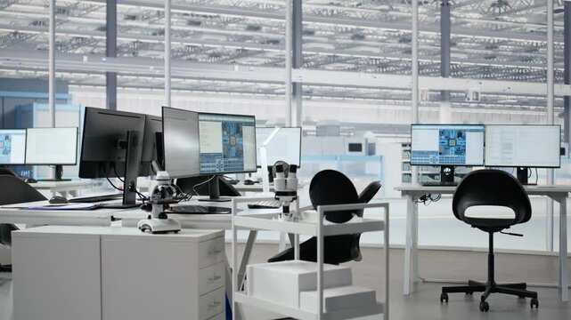 Empty semiconductor engineering office with computers used to analyze microchip systems, research workspace with digital screens used to develop PCBs for electronics devices.