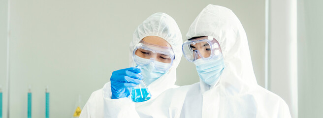 Fototapeta premium Banner Two asian scientist men fist bump team partner shake hands together. Banner Teamwork Men science chemistry research working in laboratory. Close up hand pharmaceutical science with copy space