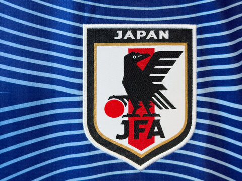 Calgary, AB, Canada. June 15, 2026. Close-up of an embroidered Japan national football team JFA crest on a blue striped jersey.