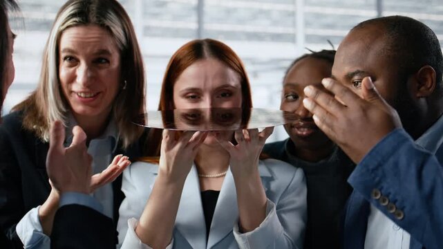 Diverse researchers examining silicon wafer close up in factory office trialing advanced materials.