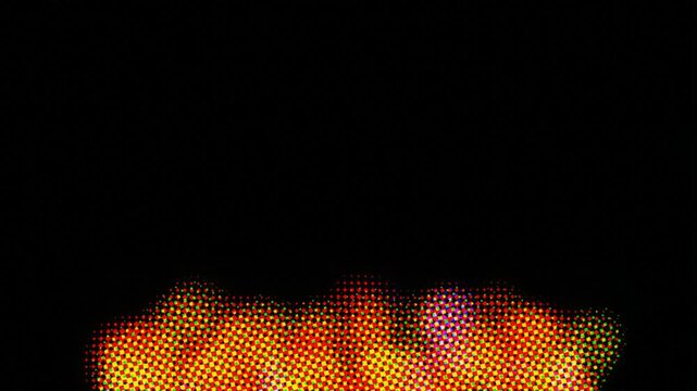 Halftone pixel fire animation flickering against black background. 4K Video