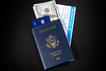 US passport with boarding pass dollars and credit card. Travel documents for airport check in and international flight concept. American passport and money theme. Boarding pass and payment card. © Svitlana