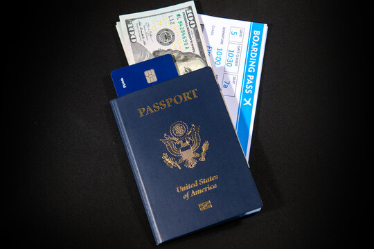 US passport with boarding pass dollars and credit card. Travel documents for airport check in and international flight concept. American passport and money theme. Boarding pass and payment card.