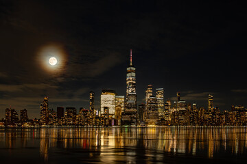 Naklejka premium NYC night panorama. New York Manhattan panorama with towers at night. New York skyline cityscape over waterfront. New York scenic Hudson river view.
