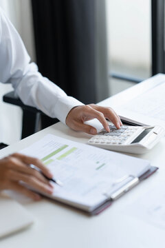 Asian businessman using calculator calculate finance company