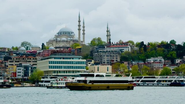 Scenic view of the historic Suleymaniye Mosque and Eminonu square background look from Bosphorus sea water with passenger ferry boat ship in Istanbul Turkey. Traditional Turkish culture landmark.