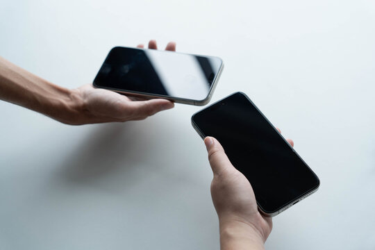 Man using smartphone close contect transfer file by wireless technology