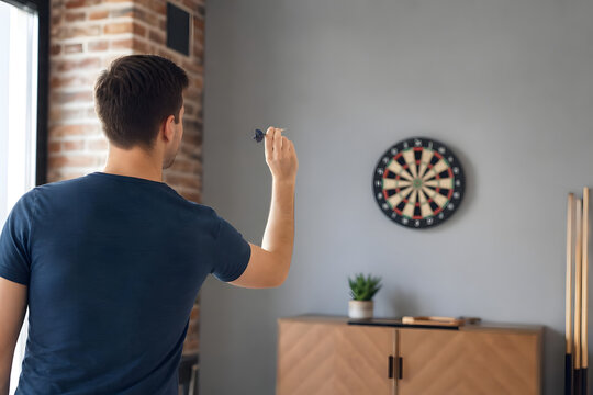 Person Throwing Darts in Home Game Room