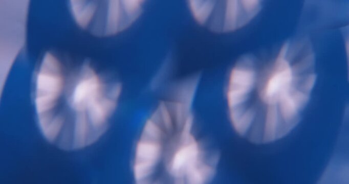 Defocused radiant reflection. Illuminated ray. Blur blue white color round optical visual gleam leaking on abstract creative background.