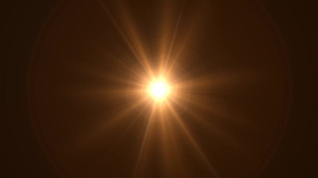 Abstract bright light burst with optical lens flare,Bright explosion of fire and light in a starry night sky with a optical lens flare.