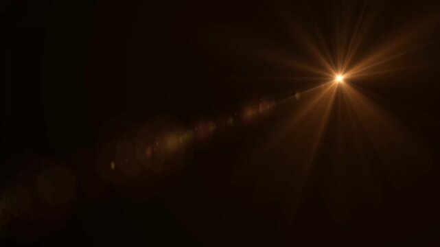 Abstract bright light burst with optical lens flare,Bright explosion of fire and light in a starry night sky with a optical lens flare.