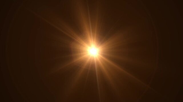 Abstract bright light burst with optical lens flare,Bright explosion of fire and light in a starry night sky with a optical lens flare.